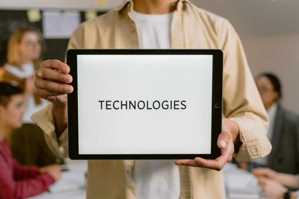 Business professionals discussing technologies, shown on a tablet in an office setting.